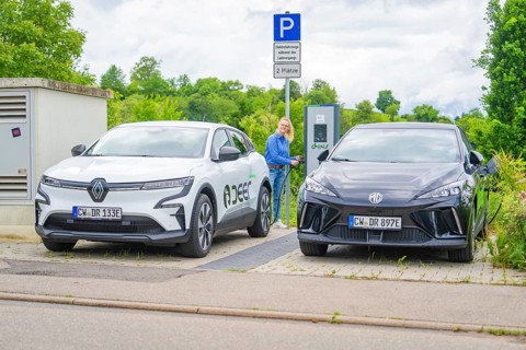 Electric cars park with a view of charging station, surrounded by green vegetation, Deer
