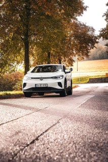 SUV on a barely traveled road, surrounded by autumn trees, deer e-car sharing, VW ID4, Calw,