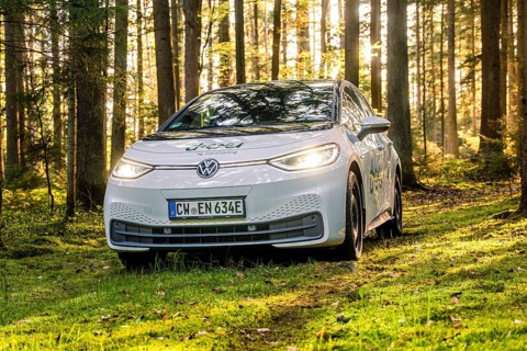 A white car in the forest with sunbeams, license plate CW EN 634E, Deer E-Carsharing, VW ID3, Calw,