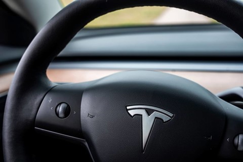 View of a Tesla steering wheel in a minimalistic car interior, Deer e-Carsharing, Tesla Model 3,
