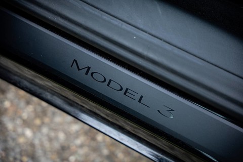 Close-up of Model 3 lettering on black metal, Deer E-Carsharing, Tesla Model 3, Calw, Germany
