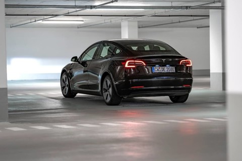 Tesla car in parking garage, illuminated by white lamps, black body, Deer E-Carsharing, Tesla Model