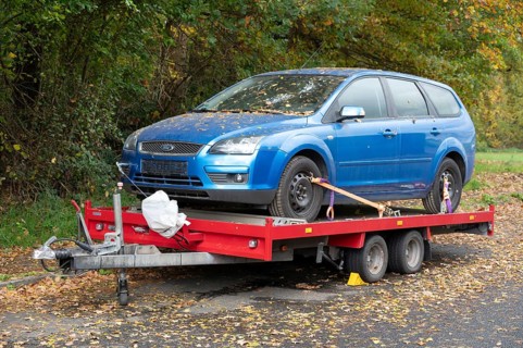 Car loaded onto a car trailer for transport, Bavaria, Germany
