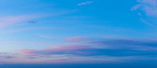 A beautiful twilight sky showcases vivid pink and blue colors as the sun sets, creating a serene