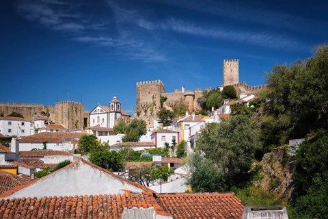 Obidos castle stands proudly above the old houses, showcasing Portugal's rich history and scenic