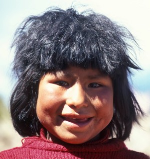 Portrait of a cheerful little girl on Isla Taquile in Lake Titicaca, Andean Highlands, Peru, South