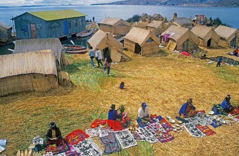 Sale of souvenirs, reed huts on a floating Uro island in Lake Titcaca, Andean highlands, Peru,
