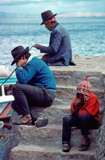 Men, boy, grandfather, father and son on Isla Taquile in Lake Titicaca, Andean Highlands, Peru,