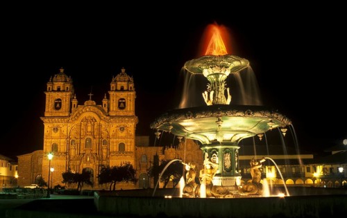 Illuminated fountain and cathedral on Placa de Armas, Cusco, Andean Highlands, South America,