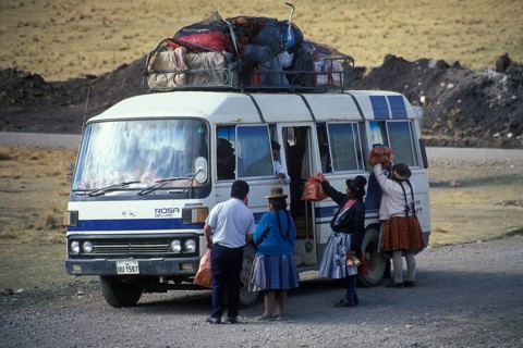 Women selling food on the side of the road to bus travelers, Andean highlands near Puno, Peru,