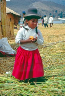 Little girl on a floating Uro island in Lake Titcaca, Andean highlands, Peru, South America,