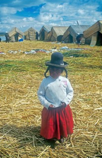 Portrait of a little girl on a floating Uro island in Lake Titcaca, Andean highlands, Peru, South