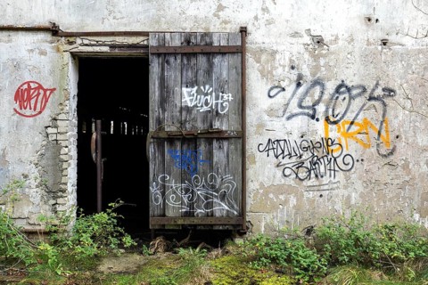 Wall with Grafity and Gate, dilapidated complex of a former agricultural production cooperative of
