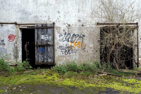 Wall with Grafity and two gates, dilapidated complex of a former agricultural production