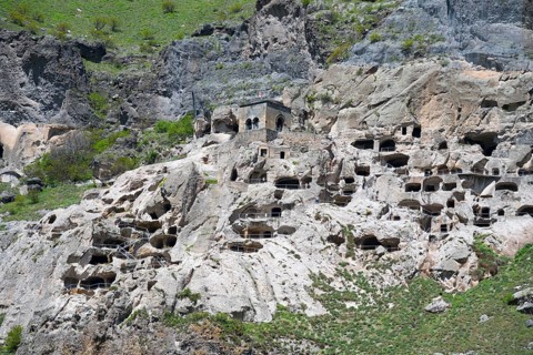 Close-up of caves artfully integrated into a rocky rock wall, cave town, cave monastery, Vardzia,