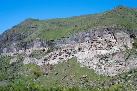 A rocky cliff wall with numerous caves on a hill, cave town, cave monastery, Vardzia,