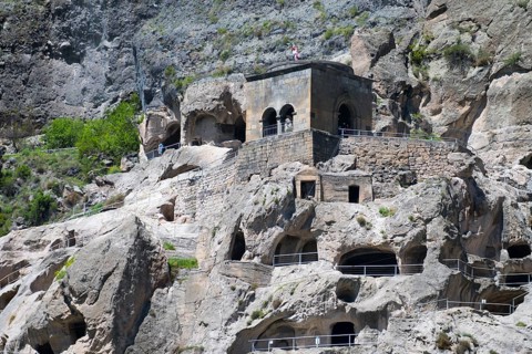 Monastery complex nestled in rocks. mixture of nature and historical architecture, cave city, cave