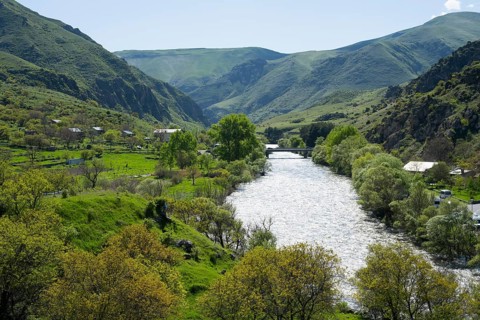 Idyllic valley with a flowing river. Hilly landscape with lush greenery, Kura river, landscape near