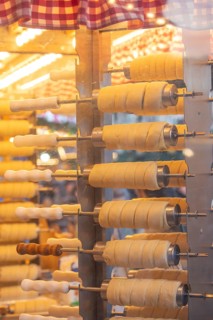 The trendy Chimney Cake stand at Stuttgart Christmas Market offers freshly baked, sweet treats. The