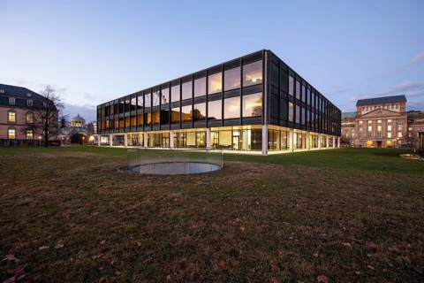 The state parliament of Stuttgart glows impressively in the evening. The architecture is