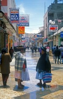 Advertising signs, people, woman, pedestrian zone in Puno, Andean highlands, Peru, South America,