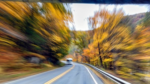 Motorhome, curvy country road, autumn leaves, Indian summer, traveling, symbolic photo, zoom