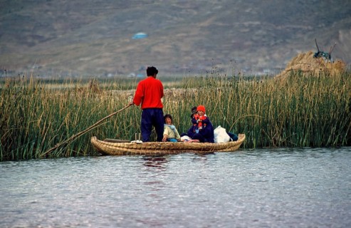Young family with young children in a reed boat, Lake Titicaca, Puno, Andean Highlands, Peru, South