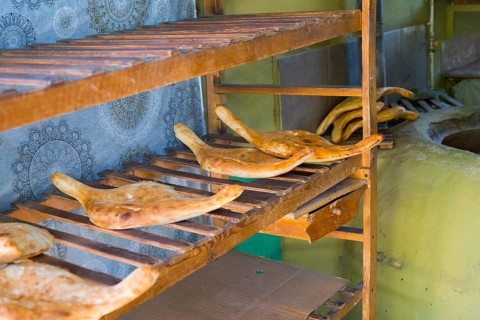 Fresh flatbread on rustic wooden shelves in a bakery, Samtskhe-Javakheti region,