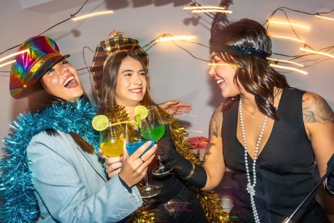 Diverse young adults at a lively new years eve costume party, dressed in festive outfits and