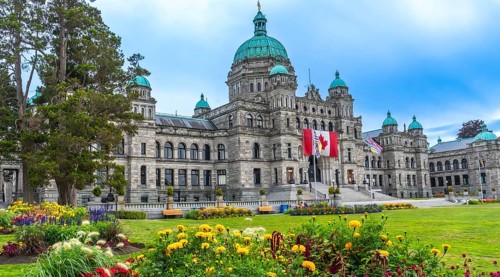 The british columbia parliament buildings stand majestically in victoria, surrounded by vibrant