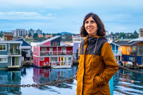 Happy tourist smiling while visiting the colorful floating houses of fisherman's wharf park in