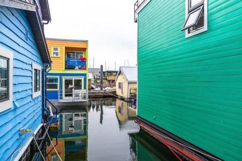 Fisherman's wharf park in victoria, british columbia, features vibrant floating homes reflecting in
