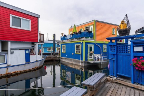 Fisherman's wharf park is showing its colorful floating homes in victoria, british columbia, a