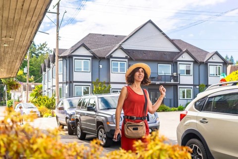 Happy female tourist strolling through chemainus, a charming town on vancouver island, british