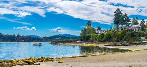 Tranquil coastal scene showcasing a motorboat sailing in the calm waters near the shores of
