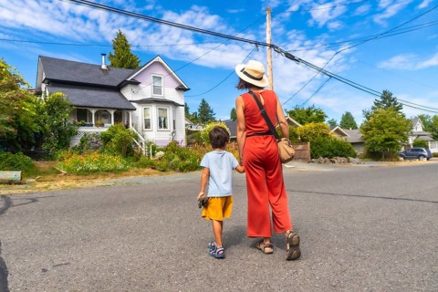 Tourist mother and son walking on a street in chemainus, vancouver island, british columbia,