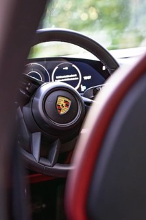 Interior of a vehicle with steering wheel and rear instruments, Porsche Taycan, Deer Carsharing,