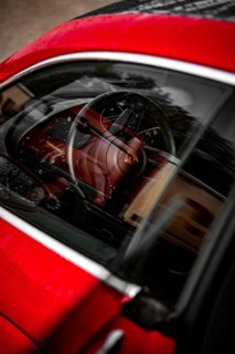 Red car interior with steering pane and reflections in the window, Porsche Taycan, Deer car sharing