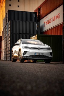 Silver car in front of high-stacked containers, VW ID4 electric car, Deer Carsharing, Calw, Germany