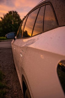 A car in the rain at sunset, reflected on wet windows, VW ID4 electric car, Deer Carsharing, Calw,