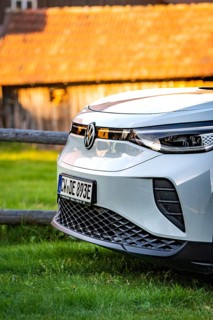 Close-up of a white car in front of a barn at sunset, VW ID4 electric car, Deer Carsharing, Calw,