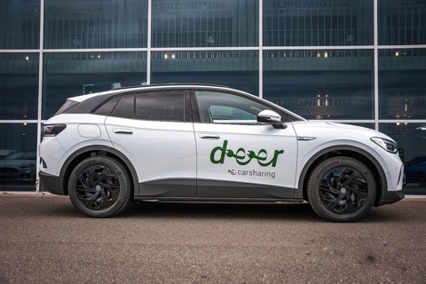 Side view of white car in front of modern offices, VW ID4 electric car, Deer Carsharing, Calw,