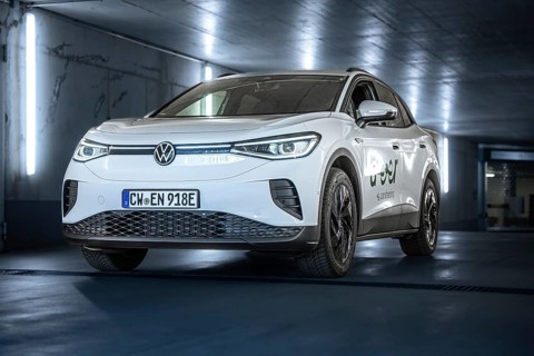 White Volkswagen in parking garage with LED lights and urban flair, VW ID4 electric car, Deer