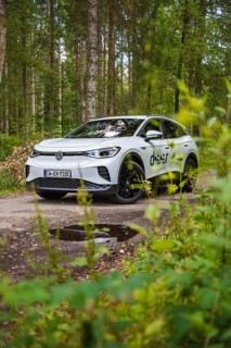 White car in the forest surrounded by green leaves, VW ID4 electric car, Deer Carsharing, Calw,