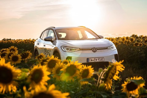 Car between sunflowers at sunset, VW ID4 electric car, Deer Carsharing, Calw, Germany