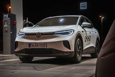 White Volkswagen at a gas station at night, VW ID4 electric car, Deer Carsharing, Calw, Germany