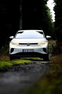 Front view of a car on a dark forest road, VW ID4 electric car, Deer Carsharing, Calw, Germany