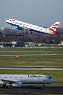 Lufthansa Airbus A321-200 on taxiway for takeoff, British Airways Airbus A320-200 on takeoff,