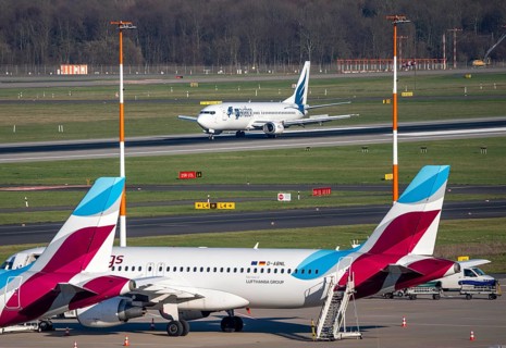 Boeing 737-400 of Bulgarian airline GP Aviation Limited landing, Eurowings aircraft parked in
