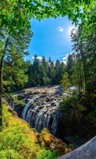 Cascading over rocks, englishman river falls creates a stunning spectacle amidst a vibrant green